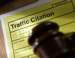 a traffic citation form and gavel on a desk